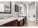 Double vanity bathroom with granite countertops and a bathtub at 4698 W Harrison St, Chandler, AZ 85226