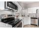 Stainless steel appliances and white cabinetry in this updated kitchen at 4698 W Harrison St, Chandler, AZ 85226