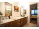 Elegant bathroom with double sinks, large mirror, and bedroom view at 5250 E Deer Valley Dr # 403, Phoenix, AZ 85054