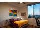 Bedroom with queen bed, desk, and city view at 5250 E Deer Valley Dr # 403, Phoenix, AZ 85054