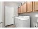 Laundry room with washer, dryer, and upper cabinets at 5317 W Glenview Pl, Chandler, AZ 85226