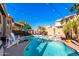 Inviting backyard oasis featuring a sparkling pool, lush landscaping, and string lights at 544 W Sierra Madre Ave, Gilbert, AZ 85233