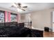 Spacious bedroom with ceiling fan and dark wood furniture at 544 W Sierra Madre Ave, Gilbert, AZ 85233