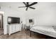 Well-lit bedroom with TV and built-in vanity at 544 W Sierra Madre Ave, Gilbert, AZ 85233