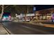 Night shot of a commercial district with illuminated restaurants and shops, capturing a lively atmosphere with pedestrian activity at 544 W Sierra Madre Ave, Gilbert, AZ 85233