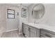 Modern bathroom with a large vanity and a round mirror at 6328 N 126Th Ave, Litchfield Park, AZ 85340