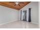 Bright bedroom with wood ceiling, tile floors, and sliding glass door at 6328 N 126Th Ave, Litchfield Park, AZ 85340