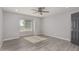 Well-lit bedroom with hardwood floor and large window at 6328 N 126Th Ave, Litchfield Park, AZ 85340