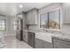 Modern kitchen with gray cabinets, farmhouse sink, and granite countertops at 6328 N 126Th Ave, Litchfield Park, AZ 85340