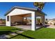 Covered patio with seating area and artificial turf at 6328 N 126Th Ave, Litchfield Park, AZ 85340