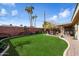 Landscaped backyard featuring a large grassy area and patio at 6437 E Cypress St, Scottsdale, AZ 85257