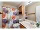 Clean bathroom with floral shower curtain and wood vanity at 6437 E Cypress St, Scottsdale, AZ 85257