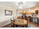 Round dining table with wooden chairs, adjacent to kitchen at 6437 E Cypress St, Scottsdale, AZ 85257