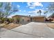 Mid-century modern home with a carport and mature trees at 6437 E Cypress St, Scottsdale, AZ 85257