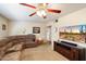 Living room with sectional sofa, large TV, and ceiling fan at 6437 E Cypress St, Scottsdale, AZ 85257