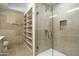 Spa-like bathroom with glass shower, built-in shelves, and tile flooring at 7120 E Kierland Blvd # 311, Scottsdale, AZ 85254