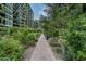 Landscaped walkway through a lush community garden, between modern residential buildings at 7120 E Kierland Blvd # 311, Scottsdale, AZ 85254