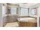 Spa-like bathroom with soaking tub, shower, and tile at 7126 E Bobwhite Way, Scottsdale, AZ 85266