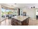 Spacious kitchen island with granite countertops and dark wood cabinets at 7126 E Bobwhite Way, Scottsdale, AZ 85266