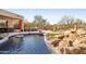 Inviting pool with a waterfall feature and a spacious patio at 7126 E Bobwhite Way, Scottsdale, AZ 85266