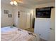 Second bedroom with a large TV and double-door closet at 7300 N 51St Ave # F91, Glendale, AZ 85301