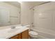 Bathroom with a tub, toilet, and wood vanity at 7334 S Morning Dew Ln, Buckeye, AZ 85326