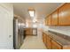 Kitchen with oak cabinets, stainless steel appliances, and tile floors at 7334 S Morning Dew Ln, Buckeye, AZ 85326