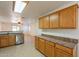 View of kitchen with oak cabinets and stainless steel appliances at 7334 S Morning Dew Ln, Buckeye, AZ 85326