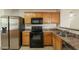 Stainless steel appliances and light oak cabinets in kitchen at 7334 S Morning Dew Ln, Buckeye, AZ 85326