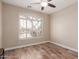 Bedroom with wood-look floors, large window, and shutters at 7432 E Melrose St, Mesa, AZ 85207