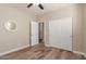 Well-lit bedroom with wood-look floors and double doors at 7432 E Melrose St, Mesa, AZ 85207