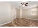 Bright bedroom featuring wood-look floors and ceiling fan at 7432 E Melrose St, Mesa, AZ 85207