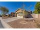 Tan house with a two-car garage and gated entry at 7432 E Melrose St, Mesa, AZ 85207