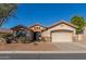 Tan house with a two-car garage and drought-tolerant landscaping at 7432 E Melrose St, Mesa, AZ 85207