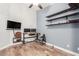 Home office with wood floors, floating shelves, and a desk at 7432 E Melrose St, Mesa, AZ 85207