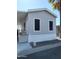 Side view of gray manufactured home with window coverings at 7807 E Main St # Ofc, Mesa, AZ 85207