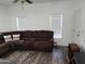 Living room with brown sectional sofa and wood-look floors at 7807 E Main St # Ofc, Mesa, AZ 85207