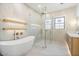 Stylish bathroom featuring a luxurious soaking tub, glass shower, and warm lighting at 8169 E Redberry --, Mesa, AZ 85207