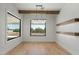 Formal dining area features modern chandelier, wood beam, and windows with natural light at 8169 E Redberry --, Mesa, AZ 85207