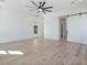 Spacious main bedroom featuring a ceiling fan, light hardwood floors, and a large barn door at 8169 E Redberry --, Mesa, AZ 85207