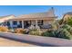 Covered patio, seating area, and desert landscaping at 8732 W Rockwood Dr, Peoria, AZ 85382