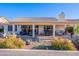 Covered patio, seating area, and desert landscaping at 8732 W Rockwood Dr, Peoria, AZ 85382