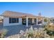 Covered patio, seating area, and desert landscaping at 8732 W Rockwood Dr, Peoria, AZ 85382