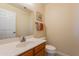 Clean bathroom with single sink vanity, toilet and mirror at 8732 W Rockwood Dr, Peoria, AZ 85382