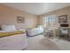 Bedroom with twin beds, a desk, and window at 8732 W Rockwood Dr, Peoria, AZ 85382