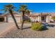 Tan two-story house with a two-car garage and palm trees at 8732 W Rockwood Dr, Peoria, AZ 85382