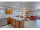 Kitchen with breakfast bar and living room view at 8732 W Rockwood Dr, Peoria, AZ 85382