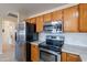 Kitchen boasts stainless steel appliances and wood cabinetry at 8732 W Rockwood Dr, Peoria, AZ 85382