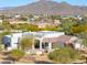 Aerial view showcasing a home's design and landscaping against a mountain backdrop at 922 E Desert Hills Estate Dr, Phoenix, AZ 85086