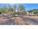 Landscaped backyard with mature trees and rock features at 922 E Desert Hills Estate Dr, Phoenix, AZ 85086